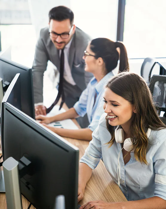 Team collaborating at computers in an office